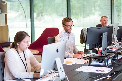 Photo of 3 office worker using computers